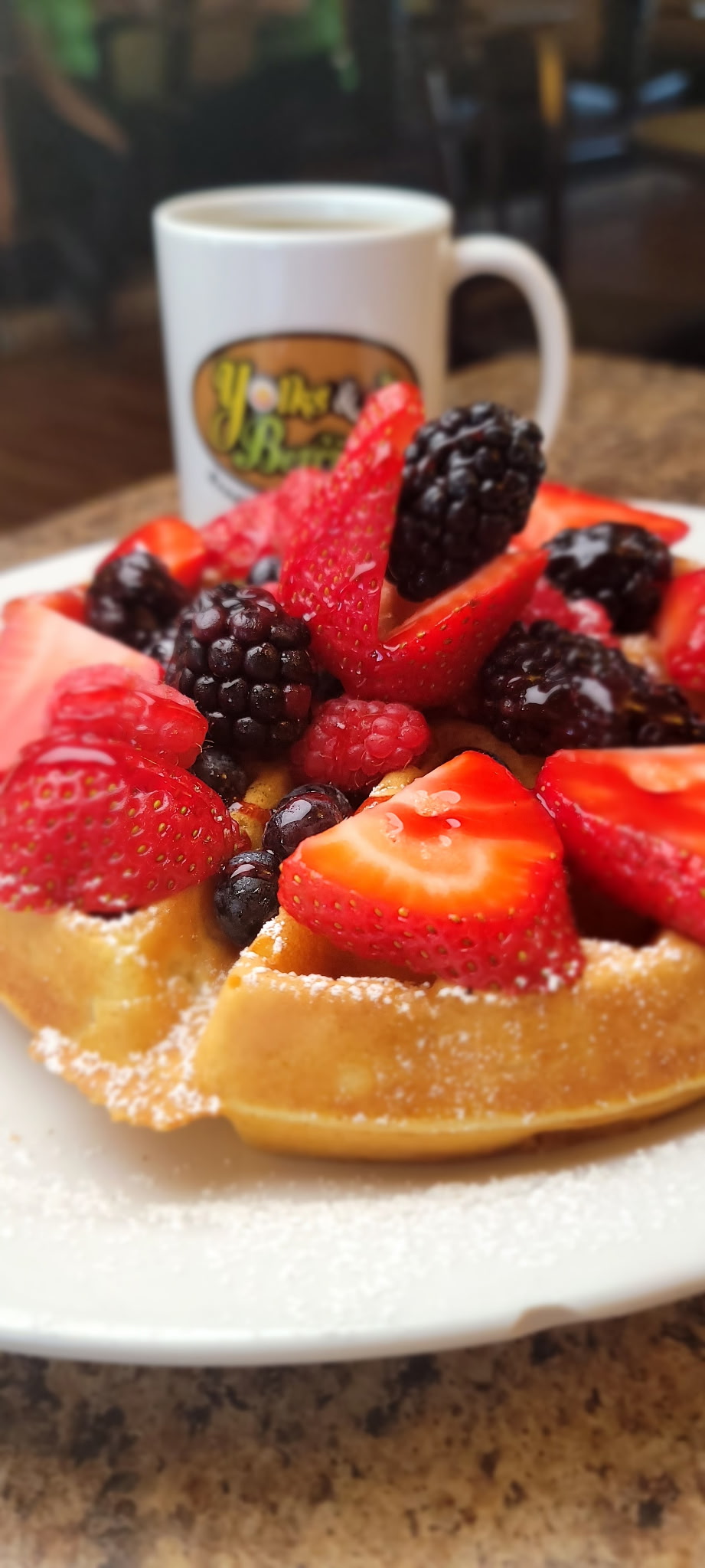 Berry waffle topped with strawberries, blackberries, blueberries, and raspberries